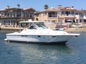 White motorboat docked near houses.