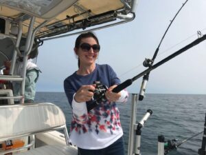 Woman fishing on a boat.