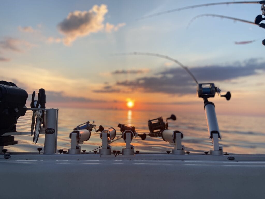 A view of the ocean from a boat at sunset.